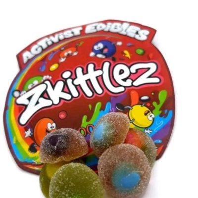 A pack of Activists Edibles Zkittlez THC Gummies, 500mg total, featuring colorful, sugar-coated gummy bites inspired by the Zkittlez strain.
