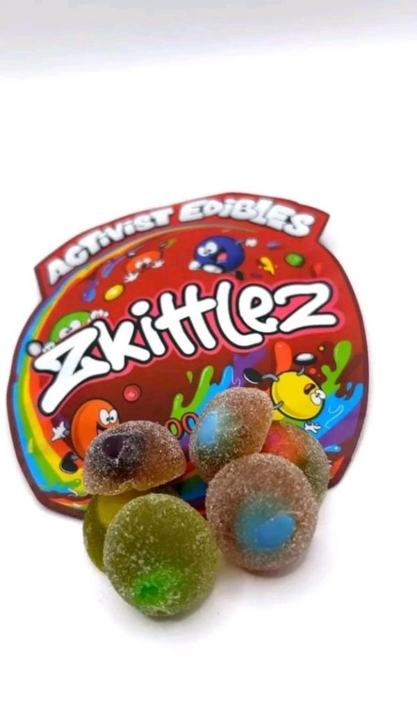 A pack of Activists Edibles Zkittlez THC Gummies, 500mg total, featuring colorful, sugar-coated gummy bites inspired by the Zkittlez strain.